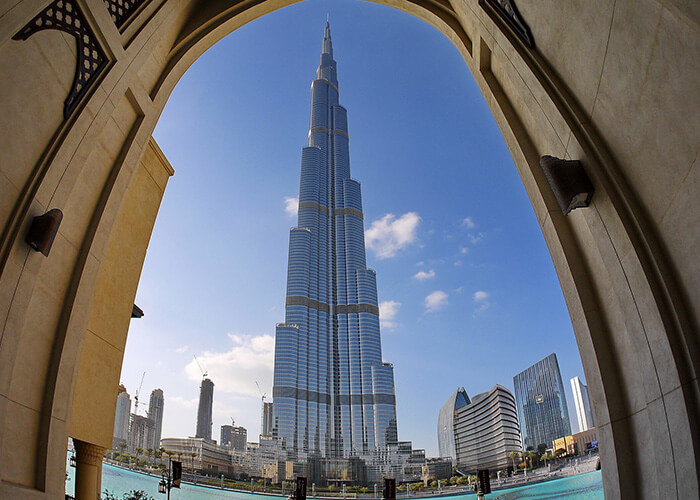 Burj Khalifa towering over Dubai skyline, framed by architectural arch, showcasing modernity and iconic design.