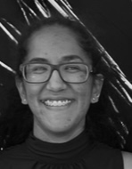Smiling young woman with glasses, showcasing a positive experience related to travel planning and family vacations.